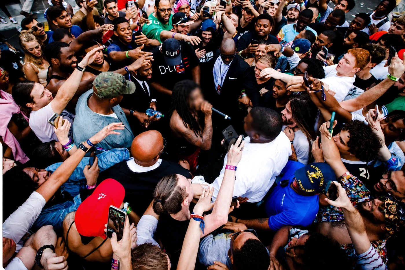 A protection team maintaining close coverage around a client in a dense crowd.
